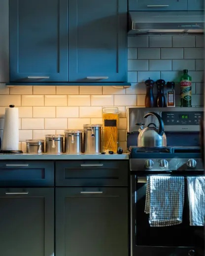 blue kitchen cabinets at night